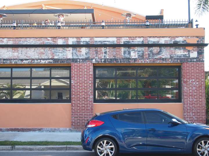 A ghost sign that barely reads Furniture on a brick building