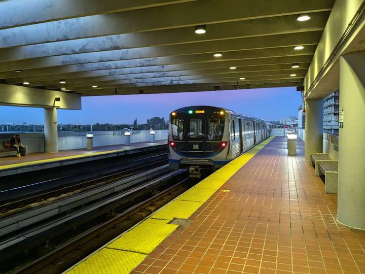 A modern metro train leaving the station