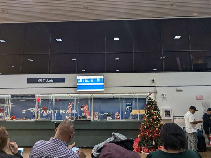 A ticket counter and another TV departures board